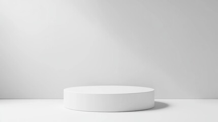 A modern white pedestal on a white surface offers blank space to add creative product images or text.