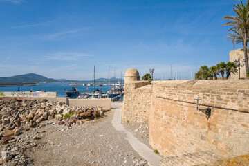 The fortifications at the seaside in Alghero in Europe, Italy, Sardinia, Alghero, in summer, on a sunny day.