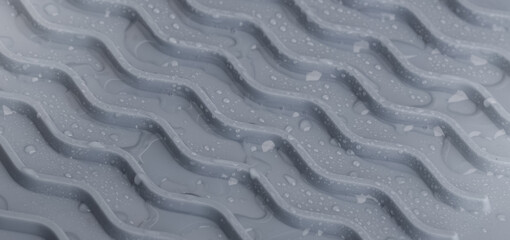 Gray silicone mat with water drops. Close-up. Background, texture