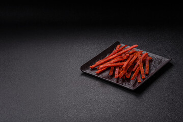 Jerky dried fish sticks with salt and spices