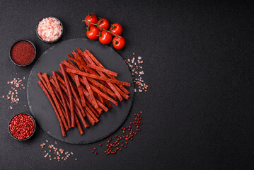 Fototapeta premium Jerky dried fish sticks with salt and spices