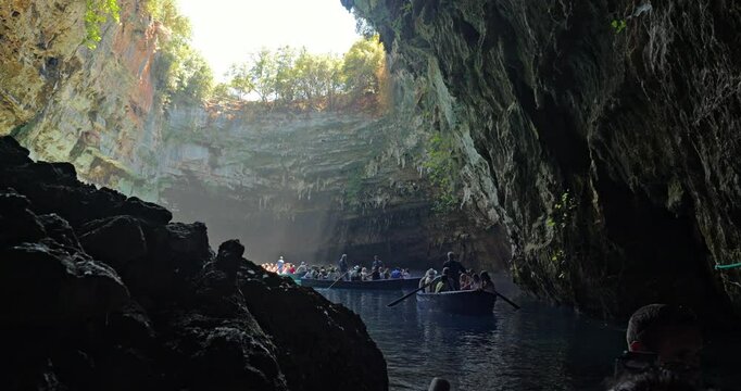 Front view POV of the visit by boat on the famous Melissani Lake in the cave without roof on Kefalonia island of Greece