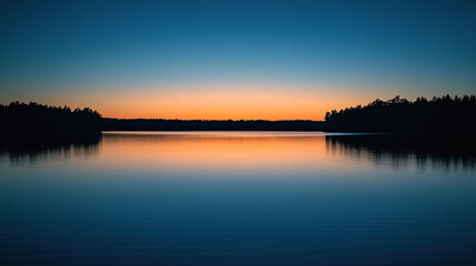 Obraz premium Tranquil Sunset Over Calm Lake with Reflection