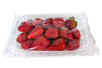 Red ripe strawberries in clear plastic package for supermarket sale. Cut out