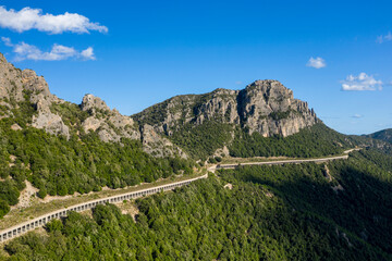The road in the Sardinian countryside between Baunei and Dorgali in Europe, Italy, Sardinia,...
