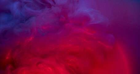 Mystical paint. Glitter spreading. Red purple violet glossy wave rolling on colorful neon water surface. Fume shiny fluid mix round lens abstract background.