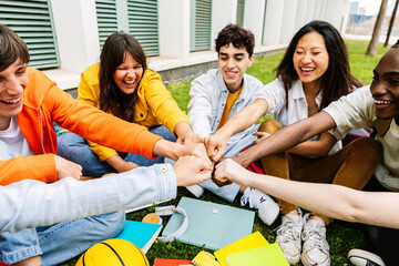 Group of college students joining hands showing support and cooperation. Youth community of diverse classmates supporting and motivating each other