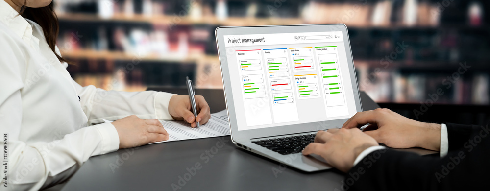 Poster project planning software for brisk business project management on the computer screen showing timel