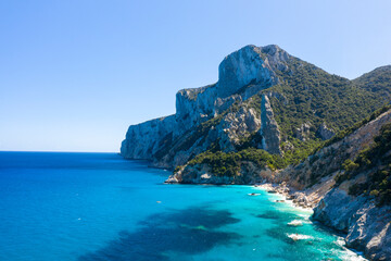 The cliffs around Cala Goloritze beach in Baunei in Europe, Italy, Sardinia, Baunei, in summer, on a sunny day.