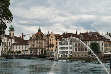  Center of Lucerne with the river Rees, the pedestrian bridge and the Jesuit church in the background.