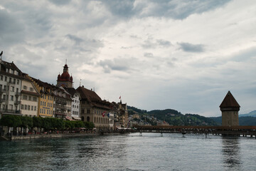 View of the Kapellbrücke bridge a bridge spanning the Reuss river in the city of Lucerne (Switzerland), during a cloudy day in spring.	