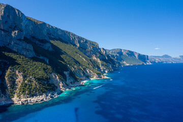 Obraz premium The cliffs around Cala Goloritze beach in Baunei in Europe, Italy, Sardinia, Baunei, in summer, on a sunny day.
