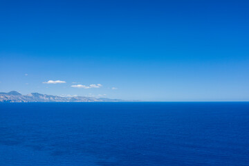 Obraz premium The Mediterranean Sea towards Cala Goloritze beach in Baunei in Europe, Italy, Sardinia, Baunei, in summer, on a sunny day.