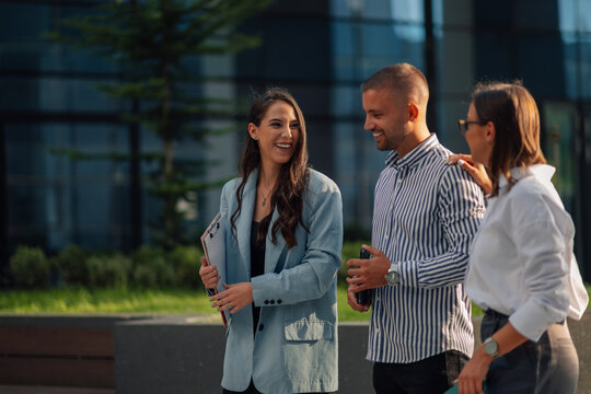 Business people having conversation walking outdoors together