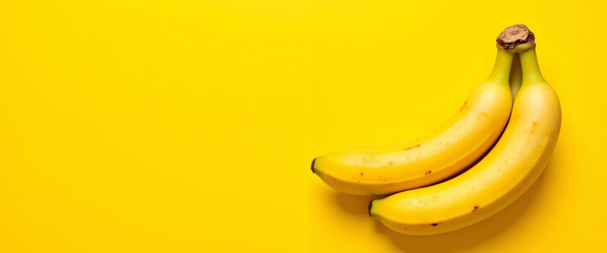 Fresh ripe bananas against a vibrant yellow background conveying a cheerful mood representing healthy eating and nutritious snacking