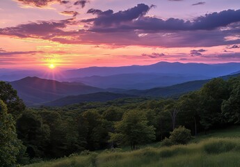 Fototapeta premium Sunset Over Rolling Hills and Valleys Showcases Vibrant Colors in the Sky Near a Lush Forest During Summer Twilight Hours