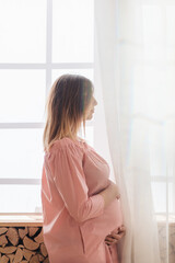 Portrait shot of young beautiful woman on third trimester of pregnancy. Close up of pregnant female...