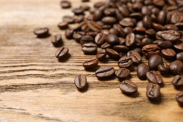 Fresh coffee beans on wooden background