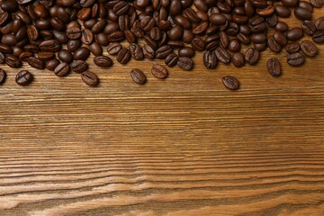 Fresh coffee beans on wooden background