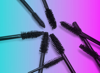 various mascara brushes on colorful background