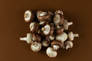 Delicious Assortment of Fresh Mushrooms Piled Together on a Rustic Brown Background Perfect for Culinary Inspiration or Healthy Dietary Choices