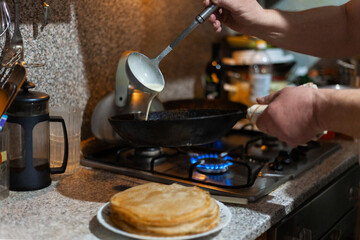 The process of making delicious thin pancakes. Delicious breakfast, Traditional food for Shrovetide.