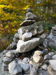 A carefully stacked stone cairn in a peaceful forest setting, symbolizing balance, mindfulness, and meditation. A perfect nature-inspired image for wellness, travel, and outdoor adventure themes