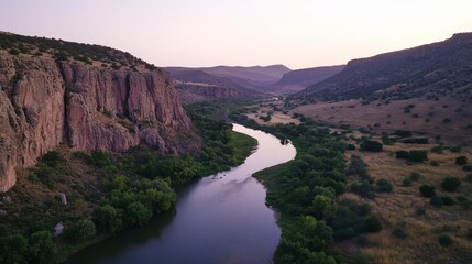 Fototapeta premium Serene River Winding Through Majestic Canyon Landscape