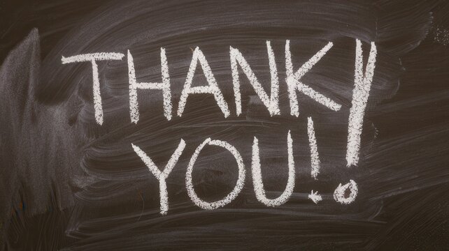 Thank you message written in white chalk on blackboard