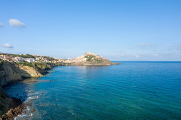Fototapeta premium The view from afar with the sea in Castelsardo in Europe, Italy, Sardinia, Castelsardo, in summer, on a sunny day.