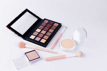 A Beautiful Array of Makeup Essentials Featuring an Eye Shadow Palette, Foundation, and Makeup...