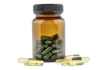 A close-up view of herbal capsules spilling from a medicine bottle on a bright surface isolated on transparent background