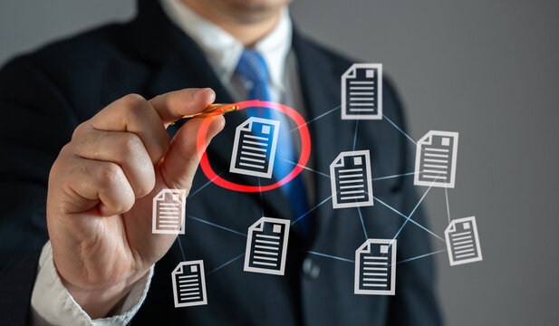 The businessman circles the required document in red. Importance, correction approvals. Urgent paperwork, or contract reviews.