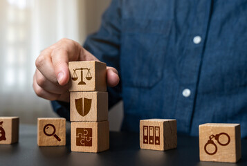 A man collects the components of the judicial system and legislation. Law, legal structure, justice, courts, legal framework, and policymaking.