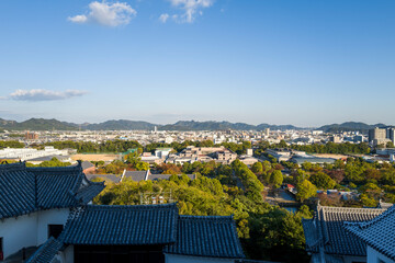 The city seen from the castle keep in Himeji in Asia, Japan, Kansai, Himeji, in summer, on a sunny...
