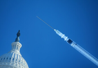 Syringe with needle pointing at government US Capitol building dome, concept of political influence on healthcare, medical policy, and vaccination mandates
