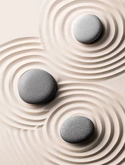Minimalist zen garden with three smooth stones creating ripple effect in sand, concept of balance and meditation