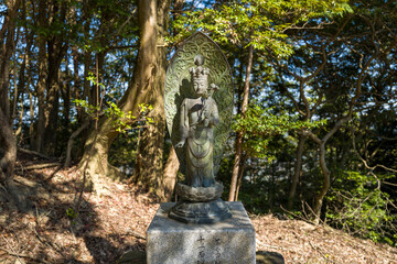 The statue on the path around the Engyoji Maniden in Himeji in Asia, Japan, Kansai, Himeji, in summer, on a sunny day.