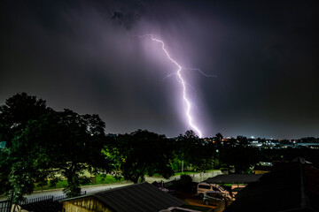 A dramatic photograph capturing powerful lightning strikes illuminating the dark sky. The jagged bolts of electricity contrast against the storm clouds, creating a breathtaking natural spectacle.
