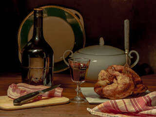 A stylized antique still life with a grilled chicken, a glass of red wine and lard. (rotisserie...