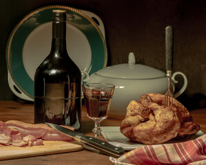 A stylized antique still life with a grilled chicken, a glass of red wine and lard. (rotisserie chicken)	