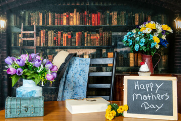 happy mothers day with flowers gifts and cupcake with old library background