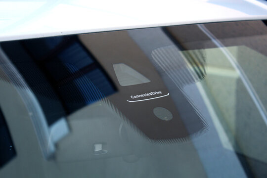 Vinnytsia, Ukraine; February 12, 2025. BMW X5 F15 Connected Drive Service. BMW iDrive. BMW Digital Key on car windshield. Windshield rain and light sensors of modern car. BMW X5 safety feature.