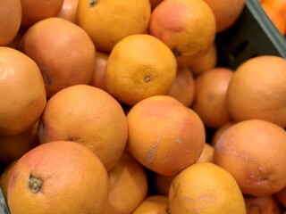 Box with ripe fresh organic tangerines on the shelf of a fruit supermarket are displayed for sale