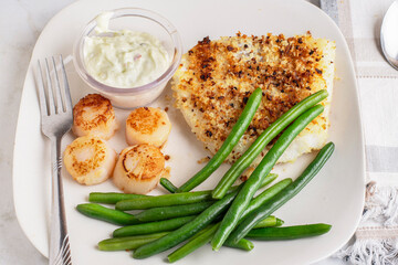 baked haddock served with scallops and green beans