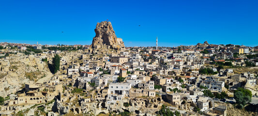 Obraz premium Panoramic view of a picturesque town with traditional architecture set amongst rocky landscapes. Stone houses, historical buildings
