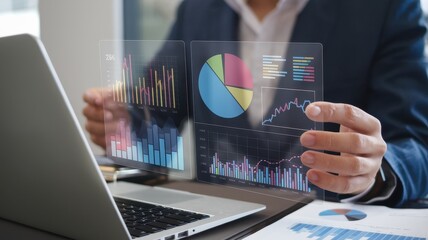 Man analyzes data visualizations using translucent futuristic screens on his desk