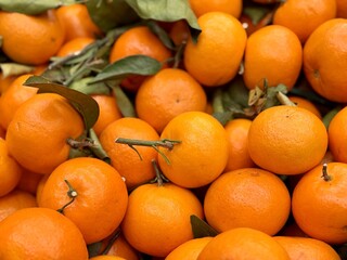 Box with ripe fresh organic tangerines on the shelf of a fruit supermarket are displayed for sale