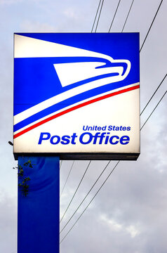 Close-up of lighted United States Post Office sign with sonic eagle logo in Theodore Alabama