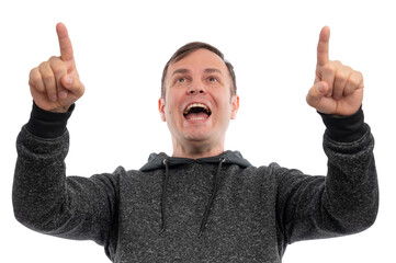 A young man in a gray hoodie smiling and pointing upwards against a white background.